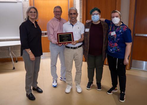 Members of Jewish Studies Department and KU senior leaders hold the Haufler Award Plaque 